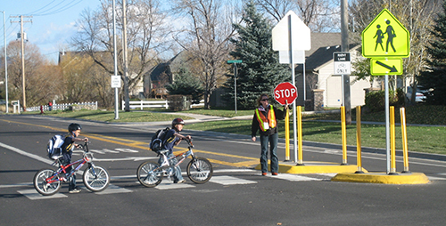 Photograph of kids on bicycles in crosswalk