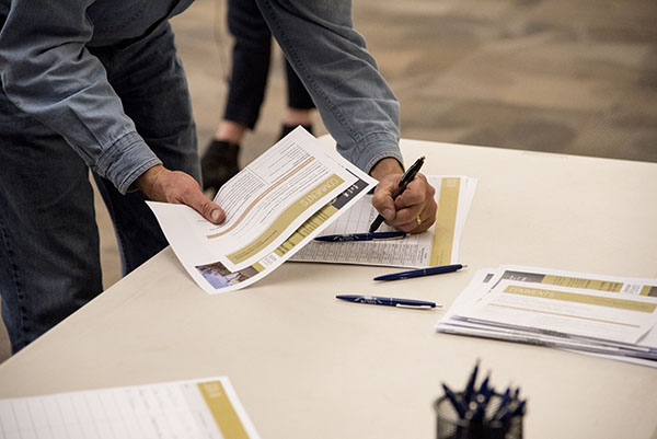 Man filling out comment form at meeting