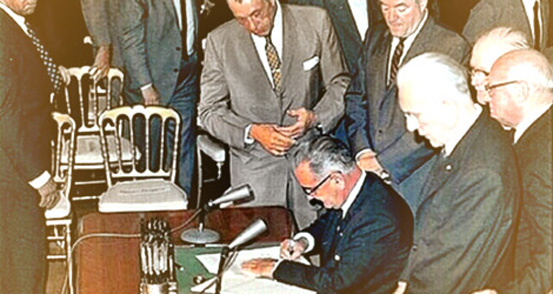 President Johnson signing Title VI documents