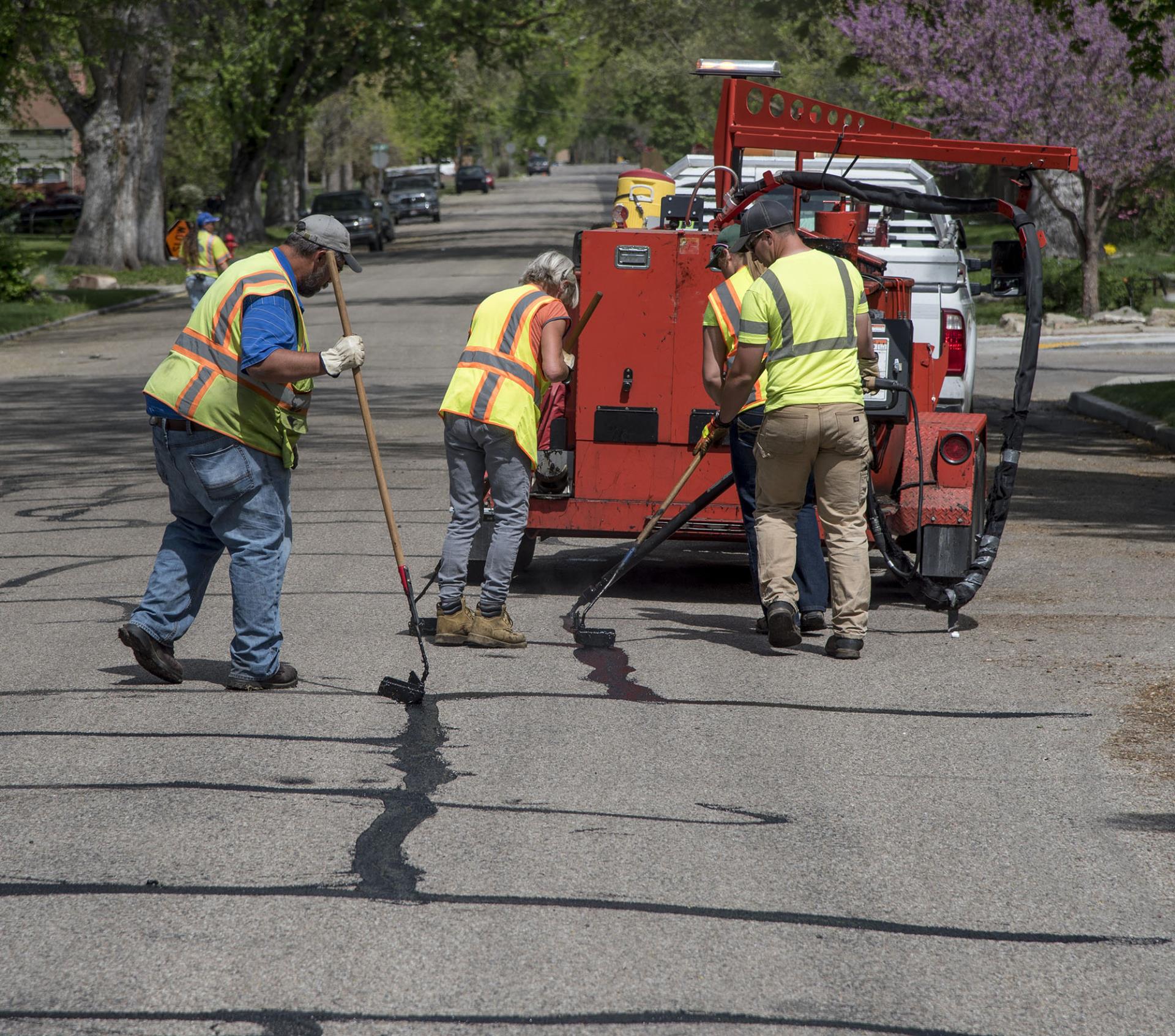 Team crack sealing on roadway